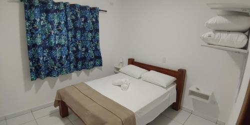 A bed or beds in a room at Residencial JL Maresias Apartamentos
