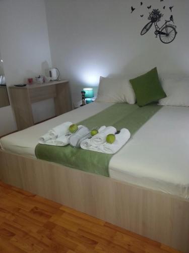 a bed with towels and fruit on top of it at The Bulevard Hotel in Skopje