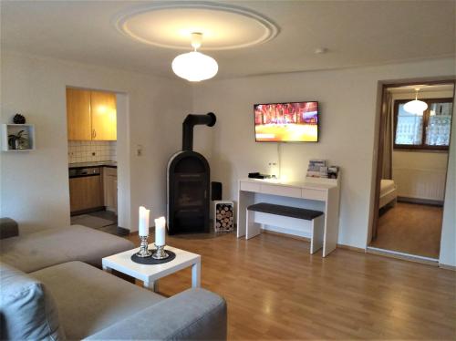 a living room with a couch and a wood stove at Ferienwohnung Julius in Innsbruck