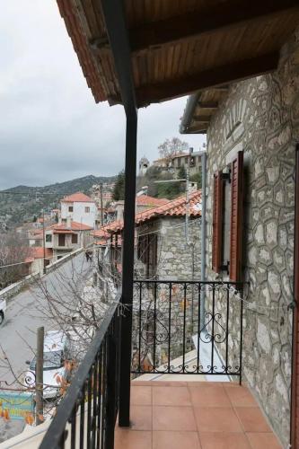 a balcony of a house with a view of a street at Sophia's Stone House in Dhimitsana
