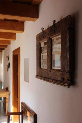 a wooden cabinet on the wall of a room at Arácsi Vendégház in Balatonfüred
