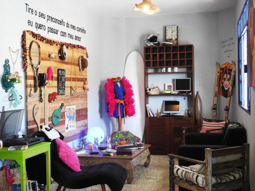 a living room with a surfboard on the wall at Soul Hostel Natal in Natal