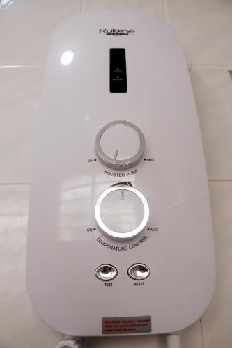 a close up of a white appliance with a scale at The Maple Homestay @ Kota Laksamana Melaka in Melaka