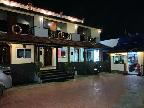 a building with a car parked in front of it at Mermaid Island Beach Resorts in Puducherry
