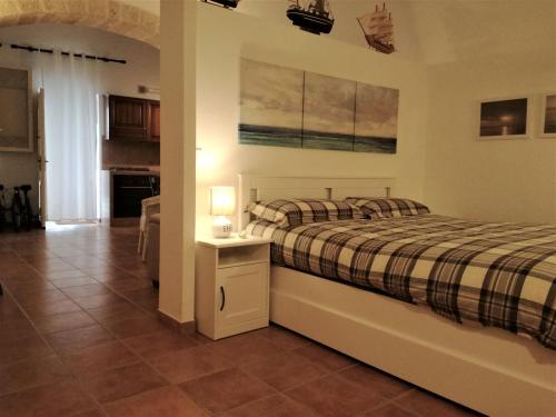 a bedroom with a bed and a table with a lamp at Alimarta in Monopoli