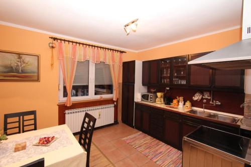a kitchen with a table and a counter top at Apartment Arcadia in Ozalj