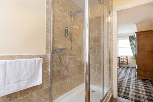 a bathroom with a shower with a glass door at Crown Lodge in Harlech