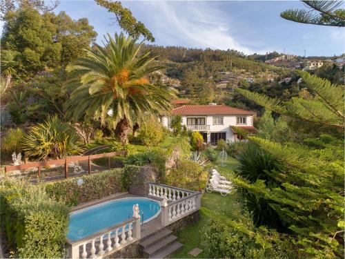 a house with a swimming pool in a garden at Pool Villa with Botanical Garden in Funchal