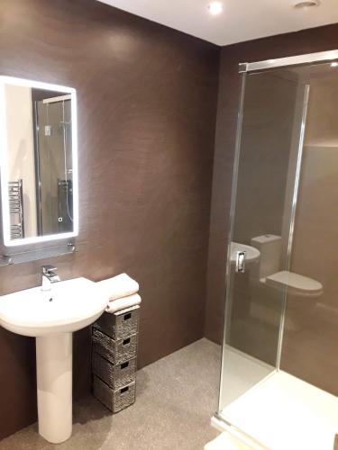 a bathroom with a sink and a shower at Kilmorie House in Elgin