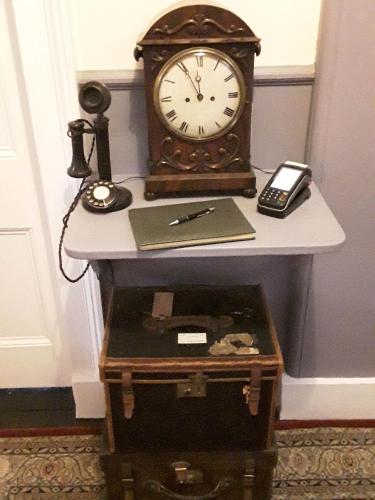 a clock sitting on top of a table at Kilmorie House in Elgin