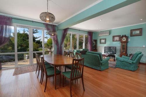 a dining room with a table and chairs at Pool Villa with Botanical Garden in Funchal