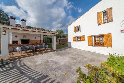 an external view of a house with a patio at Masia Can Magan Lux, Ideal Grupos 20pax in Palafolls