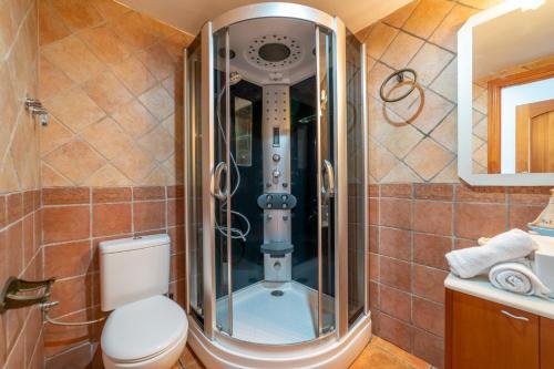 a bathroom with a shower with a toilet at Masia Can Magan Lux, Ideal Grupos 20pax in Palafolls