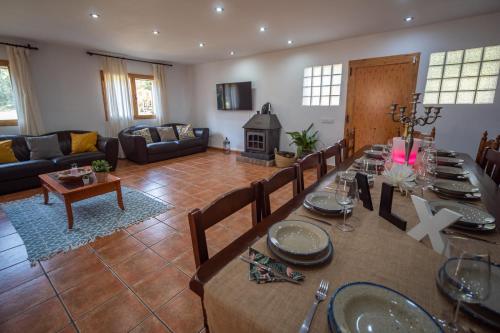 a large living room with a table and a fireplace at Masia Can Magan Lux, Ideal Grupos 20pax in Palafolls