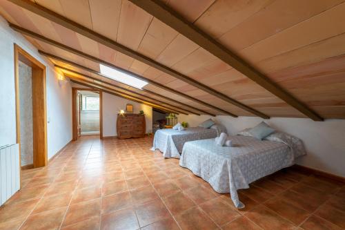 a bedroom with two beds in a room at Masia Can Magan Lux, Ideal Grupos 20pax in Palafolls