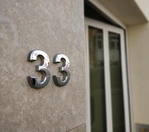 a number on the side of a building at Central Rooms - Near Valletta & Sliema - Best Bus Lines in Hamrun