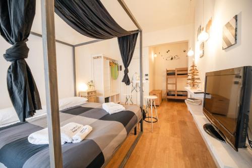 a bedroom with two beds and a flat screen tv at Le Stanze Di Brando E Nico in Tricase