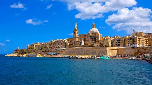 a view of a city from the water at Central Rooms - Near Valletta & Sliema - Best Bus Lines in Hamrun