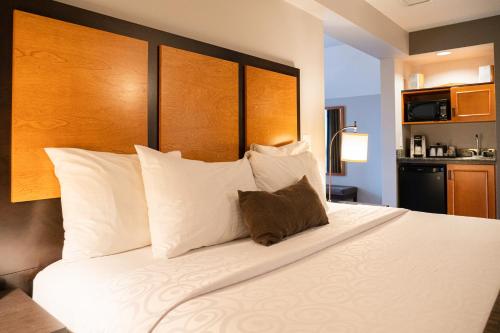 a bedroom with a large bed with white pillows at Pocaterra Inn & Waterslide in Canmore