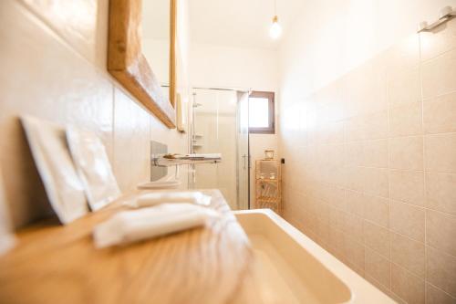 a bathroom with a sink and a tub and a mirror at Le Stanze Di Brando E Nico in Tricase
