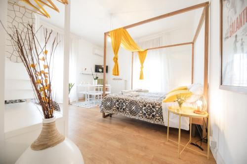a bedroom with a bed and a table and a mirror at Le Stanze Di Brando E Nico in Tricase