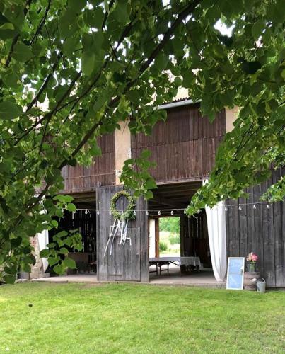 a large wooden barn with a picnic table in a yard at Ubytování NAPOLI in Stará Červená Voda