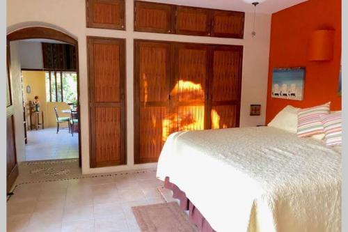 a bedroom with a white bed in a room at Newer & Roomy w/2 Pools. No Car Needed. Beaches, Restaurants & Shopping W/I walking distance. Taxis and buses abundant for reasonable price if needed in Zihuatanejo