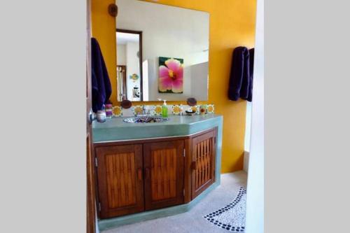 a bathroom with a sink and a mirror at Newer & Roomy w/2 Pools. No Car Needed. Beaches, Restaurants & Shopping W/I walking distance. Taxis and buses abundant for reasonable price if needed in Zihuatanejo