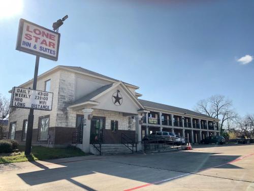 a building with a sign in front of it at Lone Star Inn & Suites in Killeen