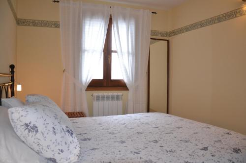 a bedroom with a large bed with a window at Casa Rural Borda Marianet in Cerler