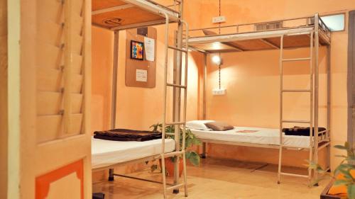 a small room with a bed and a desk at International Travellers' Hostel by ITH Stays in Varanasi