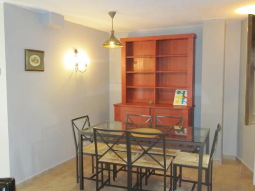 a dining room with a glass table and chairs at Casa Rural Borda Marianet in Cerler