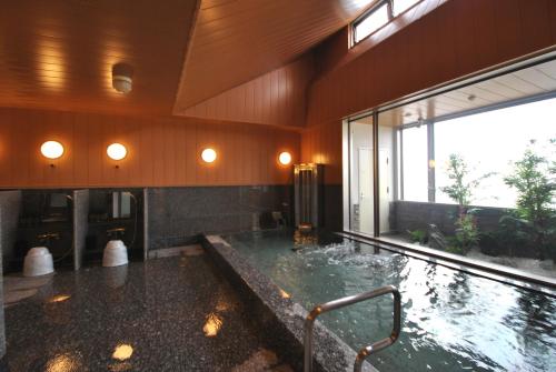 a large bathroom with a large tub with water at Hotel Mark-1 Tsukuba in Tsukuba