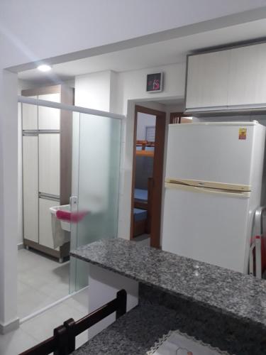eine Küche mit einem Kühlschrank und einer Arbeitsplatte in der Unterkunft Jd das Palmeiras in Ubatuba