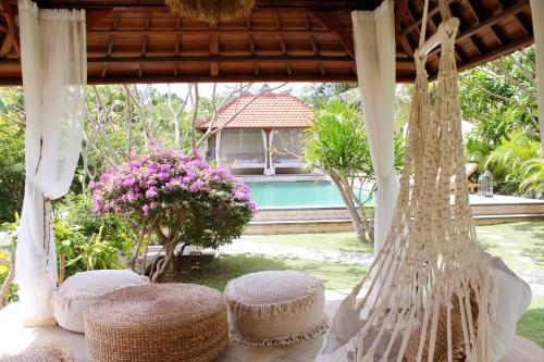 a table with hats on top of it at The Inn Possible in Uluwatu