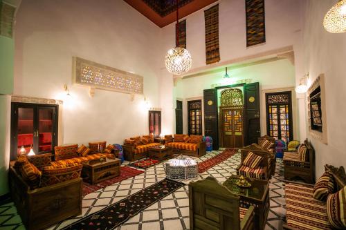 a living room with couches and chairs in a building at Dar Layali Fez in Fès