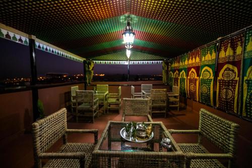 a restaurant with a table and chairs on a balcony at Dar Layali Fez in Fès