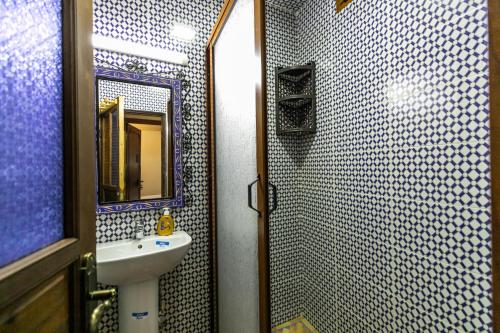 a bathroom with a sink and a mirror at Dar Layali Fez in Fès