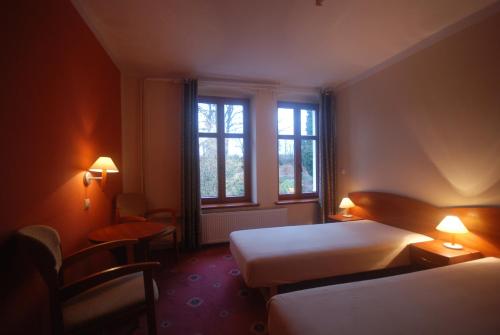 Ένα ή περισσότερα κρεβάτια σε δωμάτιο στο Rajski Dom