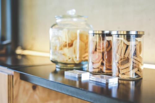 a counter with two glass jars filled with cookies at Setre Marina Biwako in Moriyama