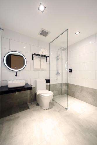 a bathroom with a toilet and a sink and a shower at ARENA Boutique Hotel Kuala Terengganu in Kuala Terengganu