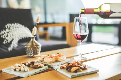 a glass of wine and some food on a table at Setre Marina Biwako in Moriyama