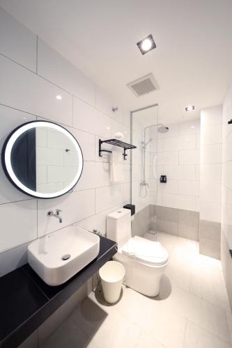 a bathroom with a sink toilet and a mirror at ARENA Boutique Hotel Kuala Terengganu in Kuala Terengganu