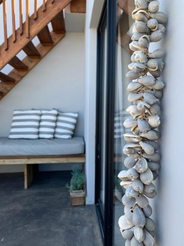 a pile of shells on a wall next to a staircase at Lower Point Surf Studio in Jeffreys Bay