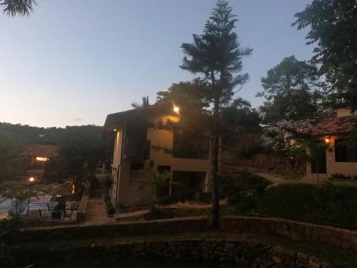 a house with a street light in front of it at Hotel Casas de Campo El Ciruelo in San Gil
