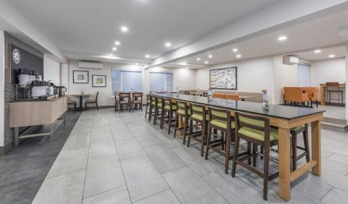 a restaurant with a bar and some tables and chairs at Holiday Inn Express Hotel & Suites Charlottetown by IHG in Charlottetown