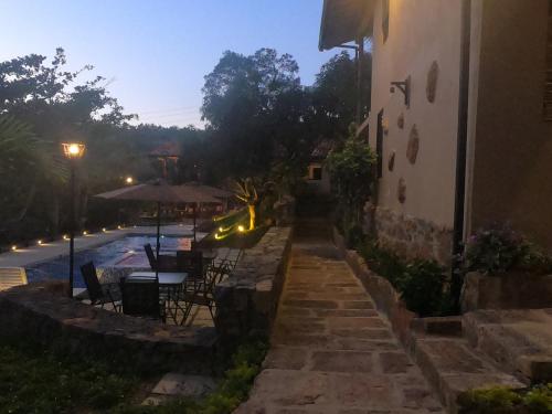a patio of a building with a table and chairs at Hotel Casas de Campo El Ciruelo in San Gil
