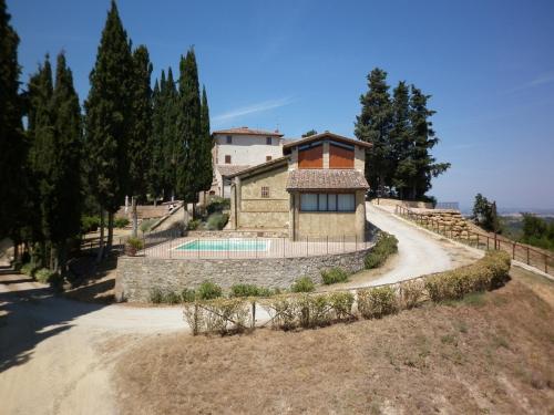 an external view of a house with a swimming pool at Podere Le Grotte in San Gimignano