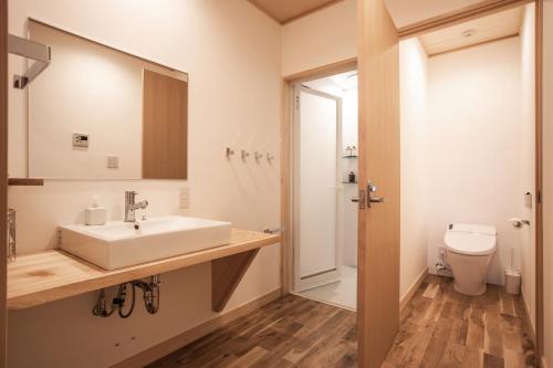 a bathroom with a sink and a toilet at 宿坊 観音院 Temple Hotel Kannonin in Kiryu