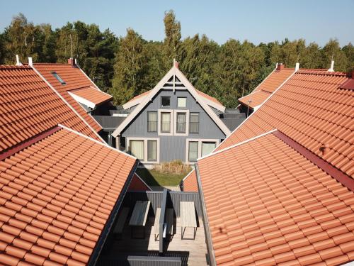 a row of roofs with a house in the middle at Nidos Namai in Nida